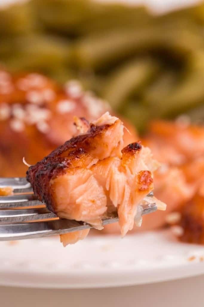 Piece of soft and juicy air fryer teriyaki salmon on fork