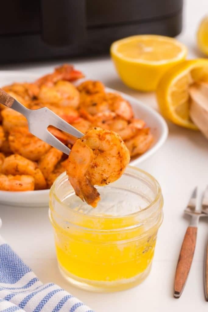 Fork dipping shrimp cooked in air fryer into sauce