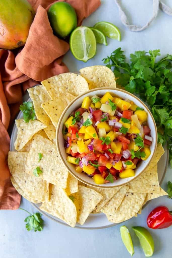 plate of tortilla chips with mango habanero salsa for dipping