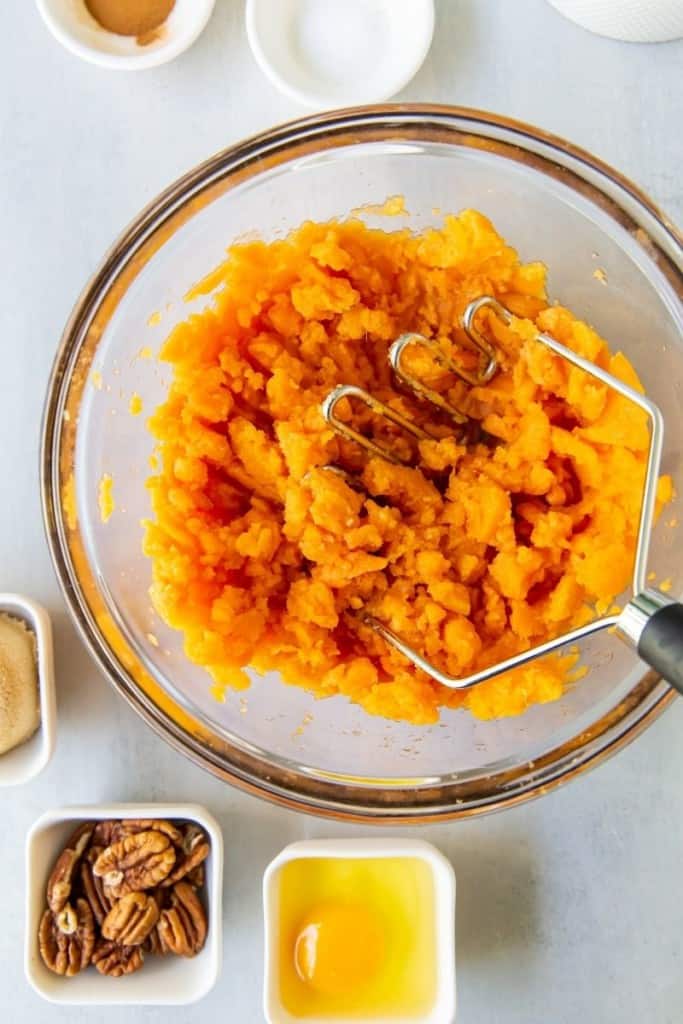 mash sweet potatoes with potato masher or wooden spoon