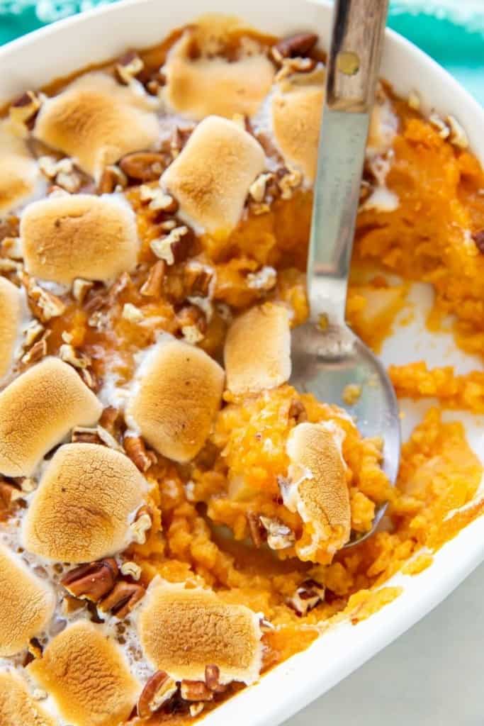 Serving spoon dishing up some sweet potato casserole