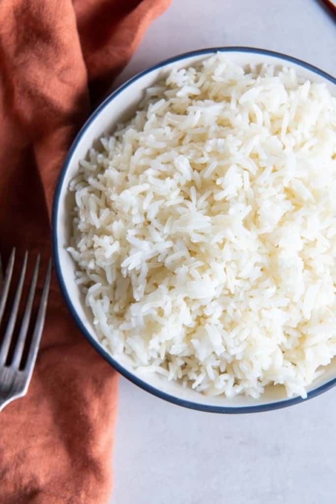 aerial shot of bowl of air fryer rice with fork on table