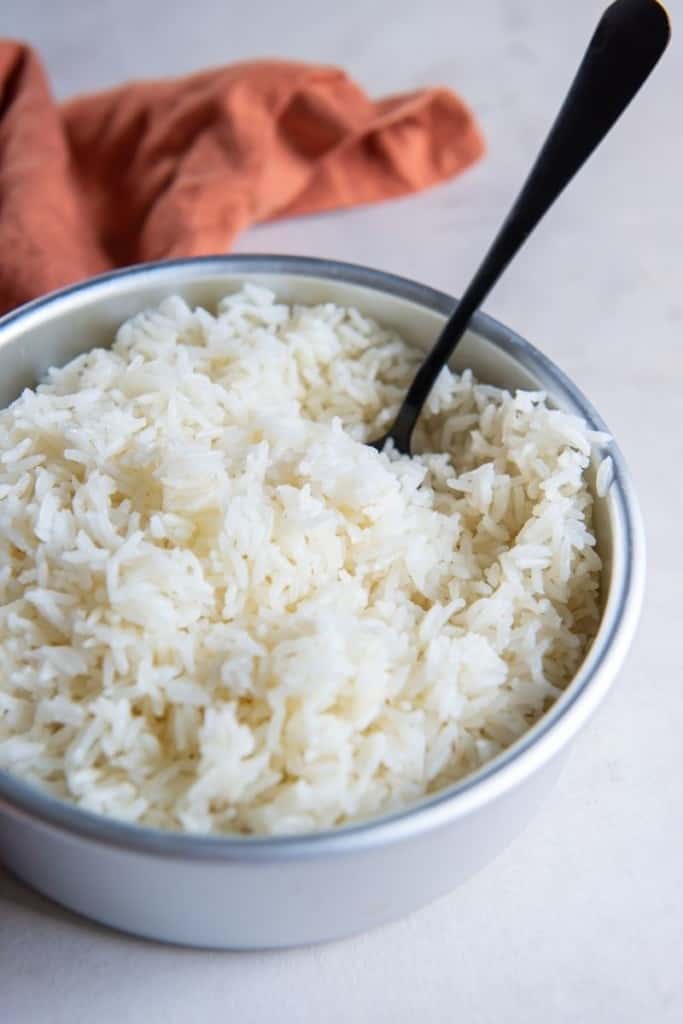 white bowl full of white rice cooked in air fryer