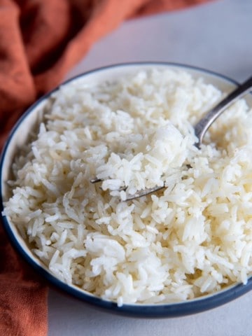 Air fryer rice in white bowl with fork
