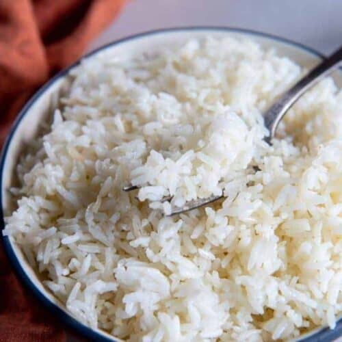 Air fryer rice in white bowl with fork