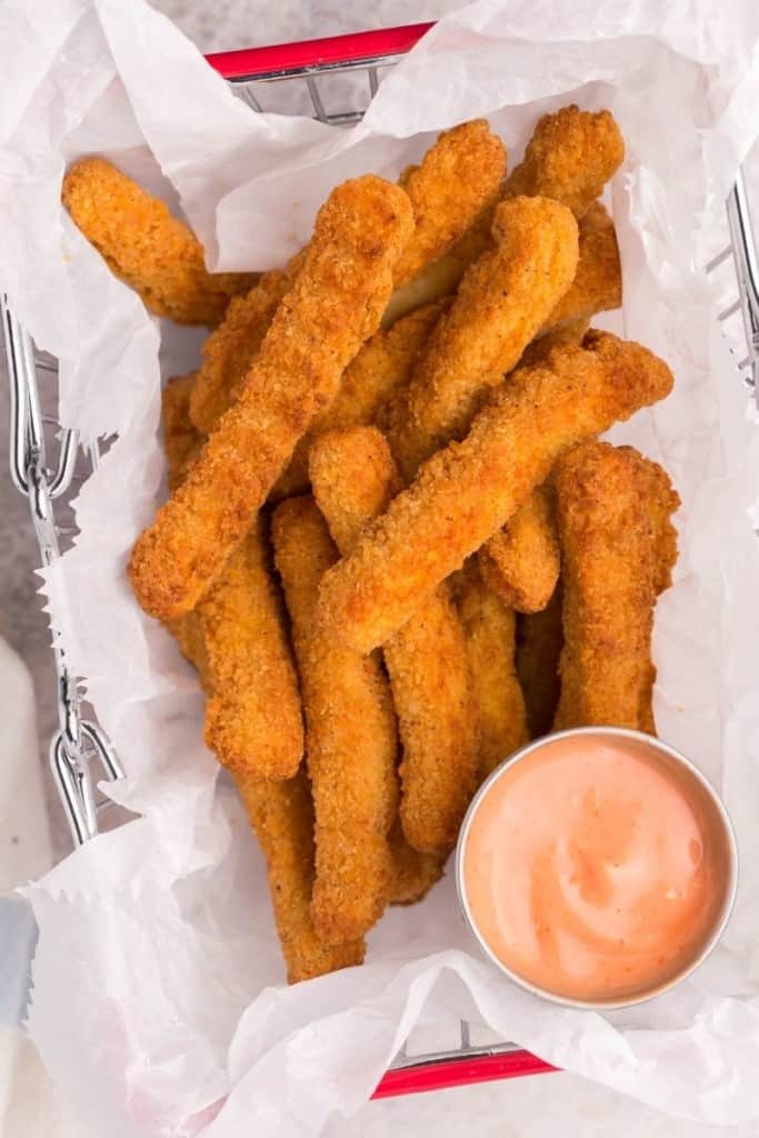 chicken fingers in basket with dipping sauce