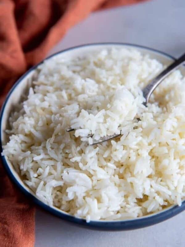 Air fryer rice in white bowl with fork