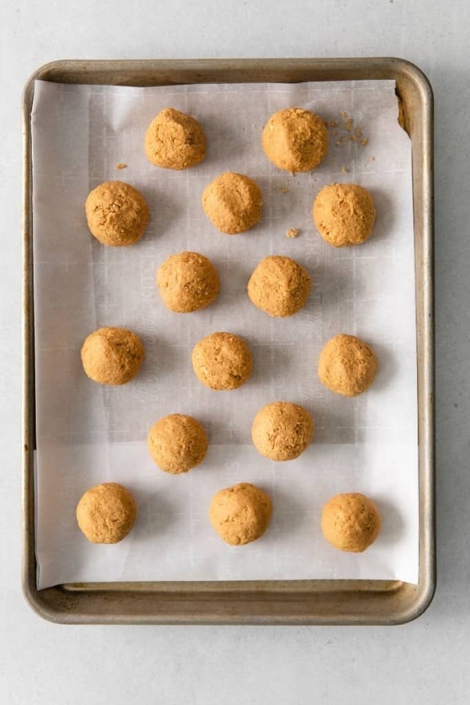 place peanut butter balls on parchment paper to chill