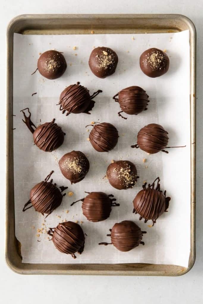 dip peanut butter balls in melted chocolate and set