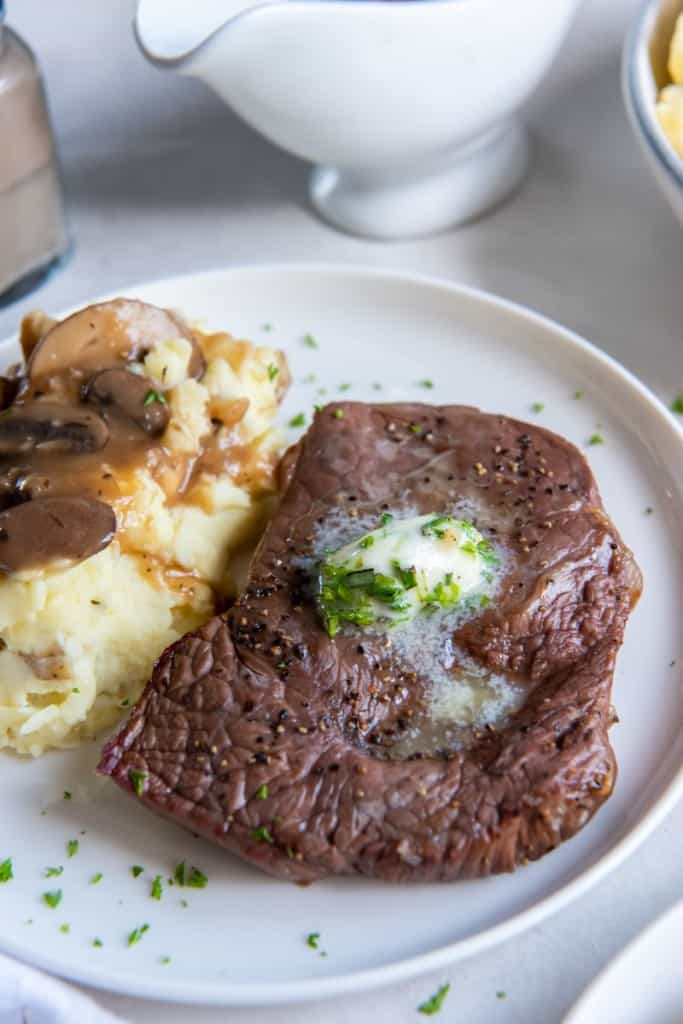 sirloin steak on a plate with potatoes