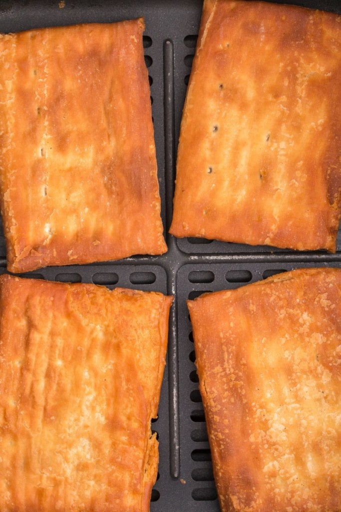 closeup of four toaster strudels in air fryer basket
