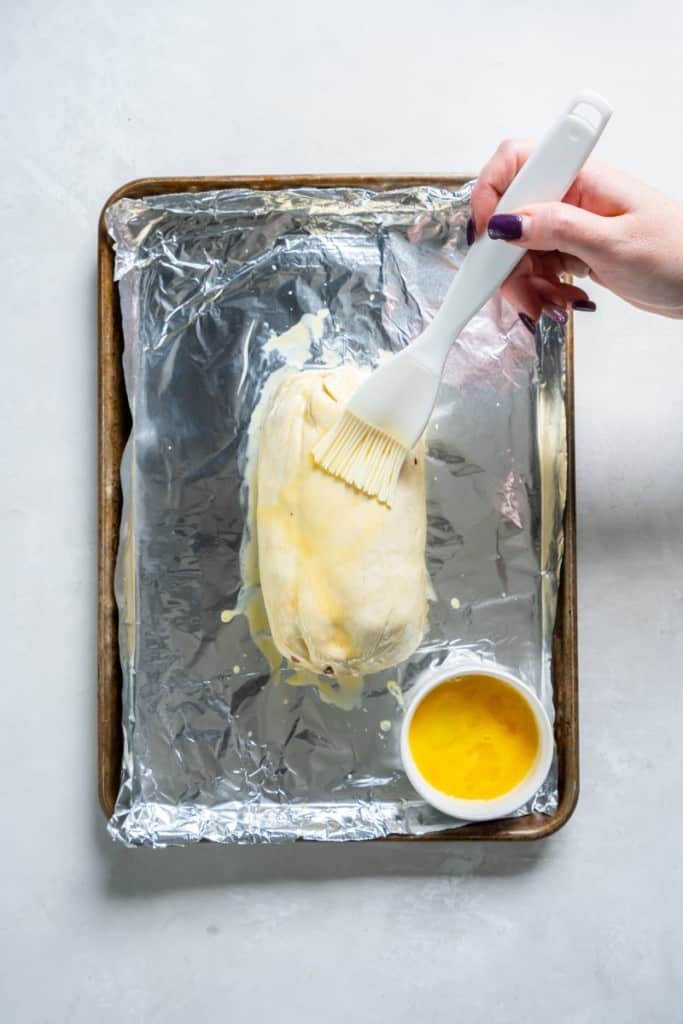 adding butter to beef wellington