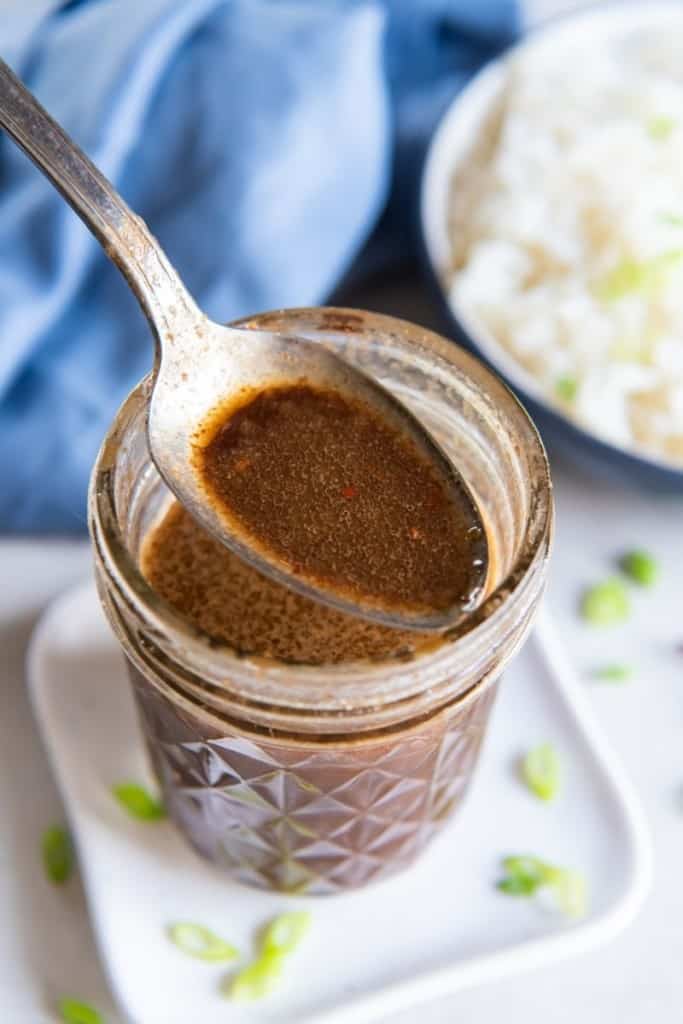 Best Stir Fry Sauce in a jar with spoon and rice