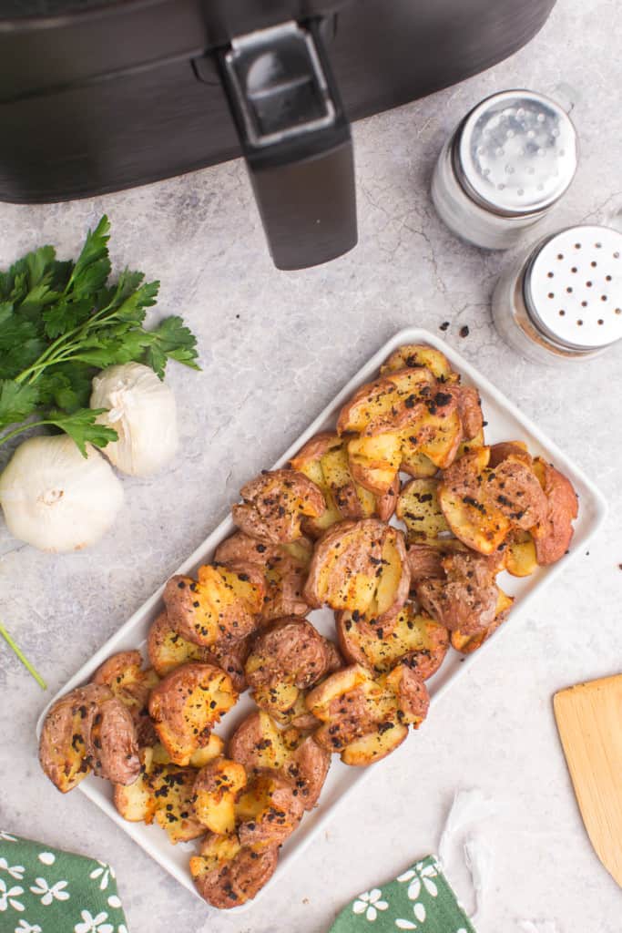 platter filled with crispy smashed potatoes