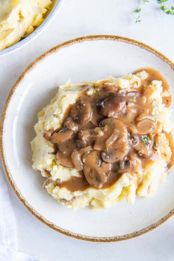 mushroom onion gravy on a bed of potatoes