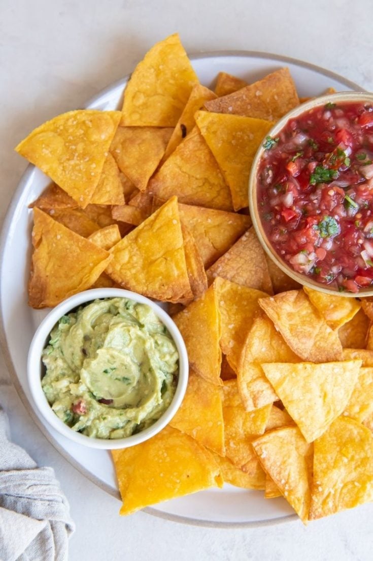 Homemade air fryer tortilla chips with guacamole and salsa