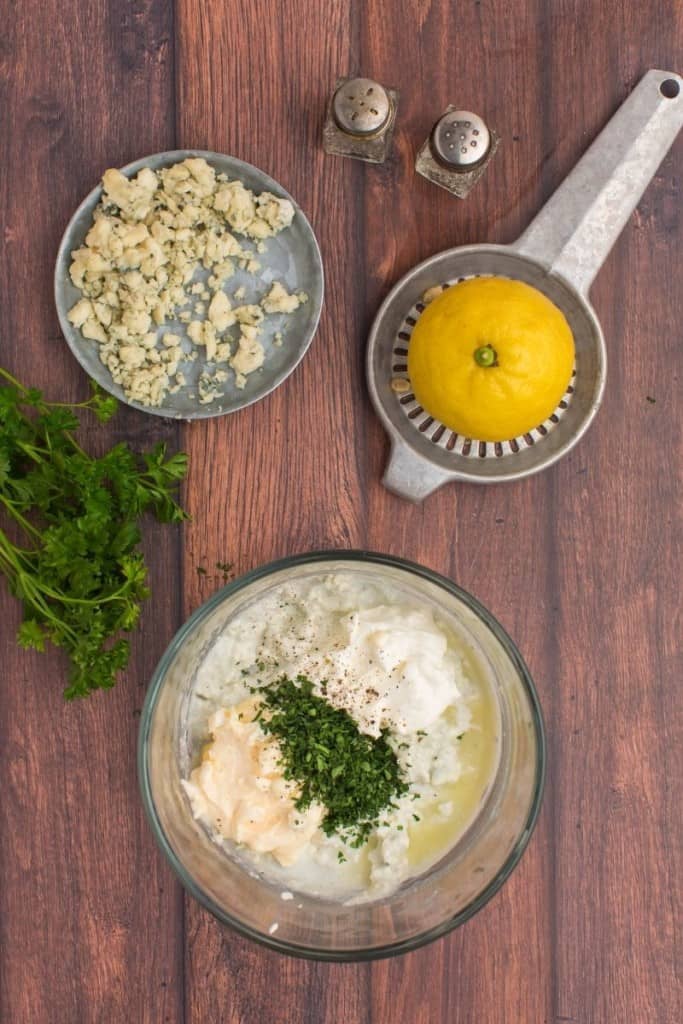 ingredients placed in bowl to make blue cheese dressing