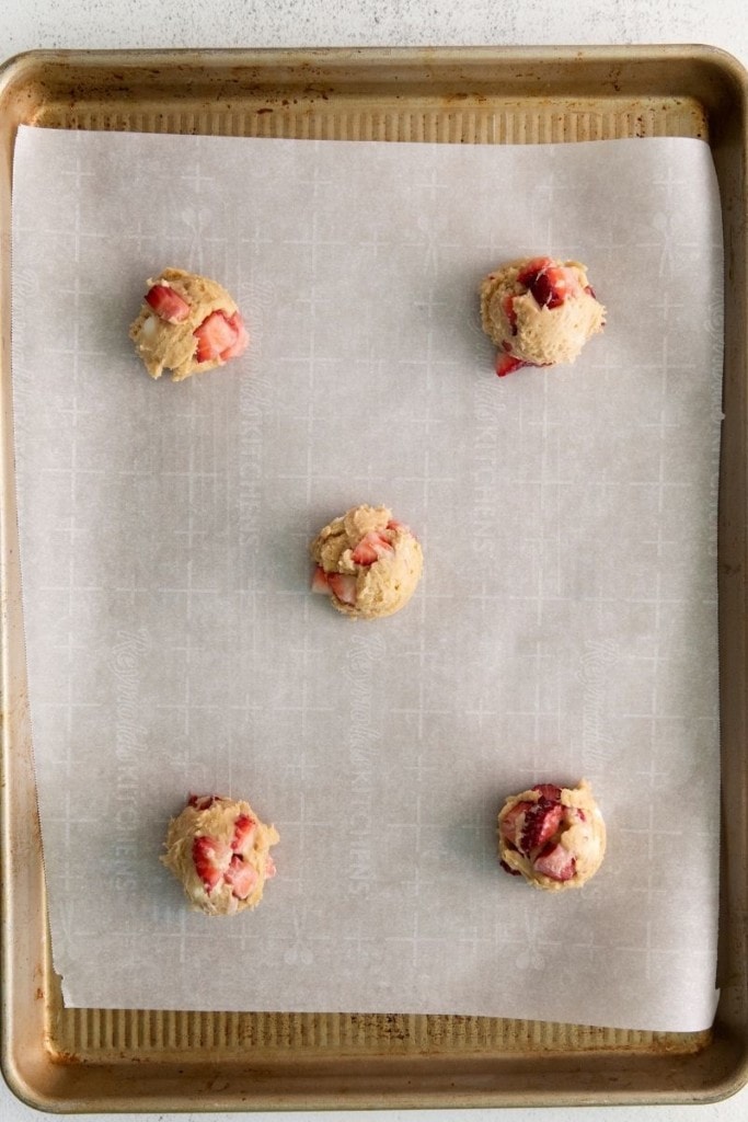 Strawberry cheesecake cookie dough on baking sheet