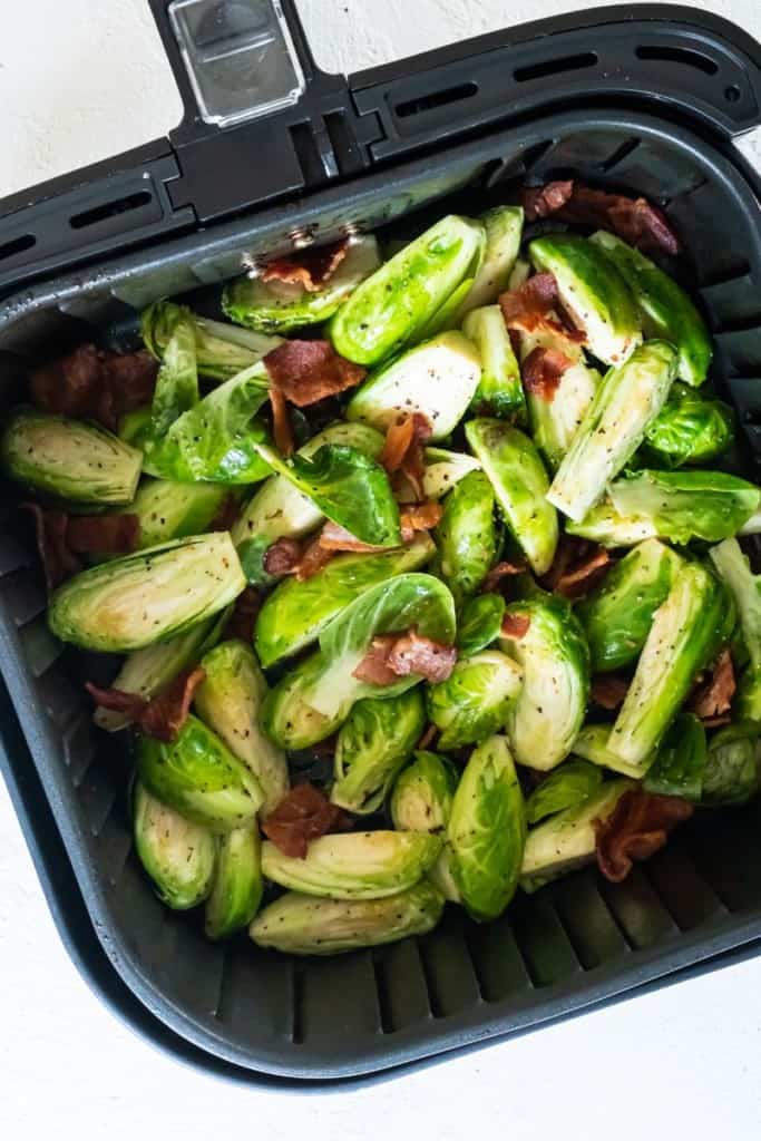 raw brussel sprouts in air fryer basket