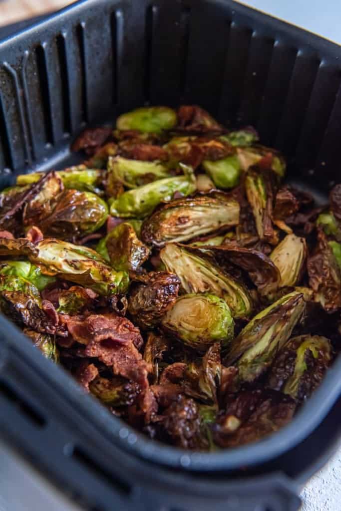 air fryer basket with cooked brussels sprouts