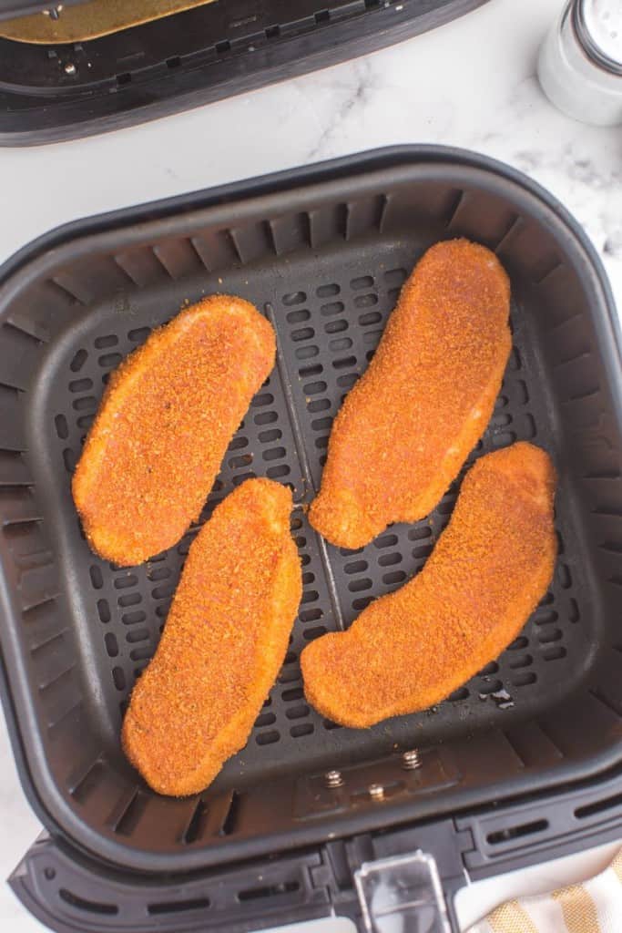 pork chops in an air fryer basket