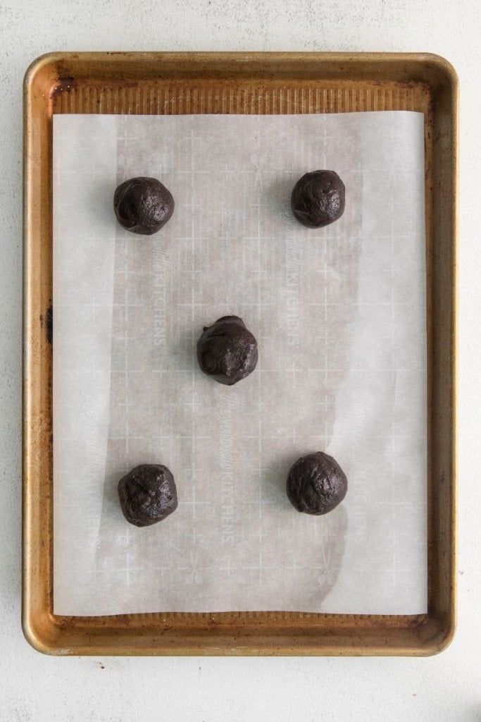 chocolate cookie batter on a baking sheet