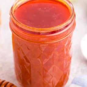 jar filled with honey hot wing sauce