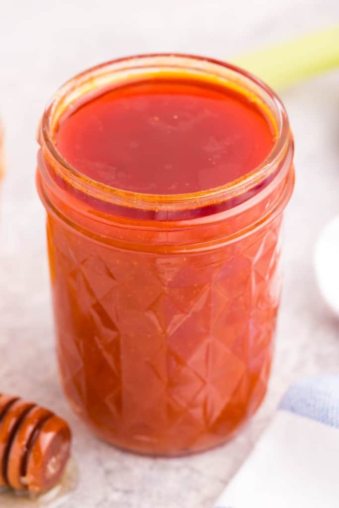 jar filled with honey hot wing sauce