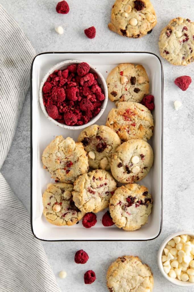 platter with raspberry cheesecake cookies and fresh raspberries