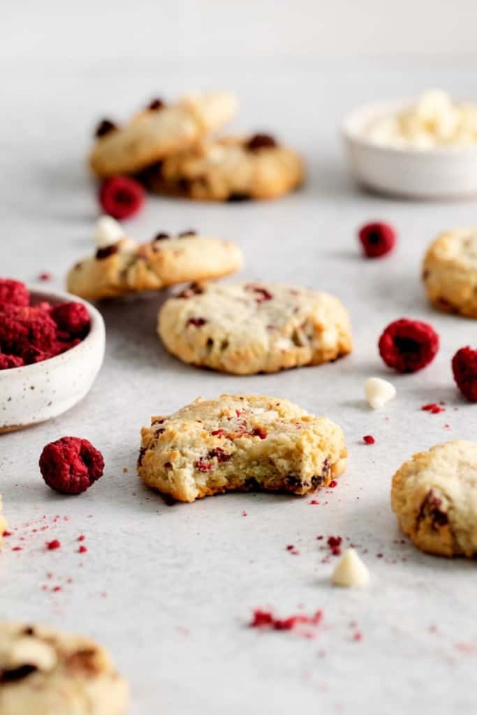 raspberry cheesecake cookies with a bite out of one