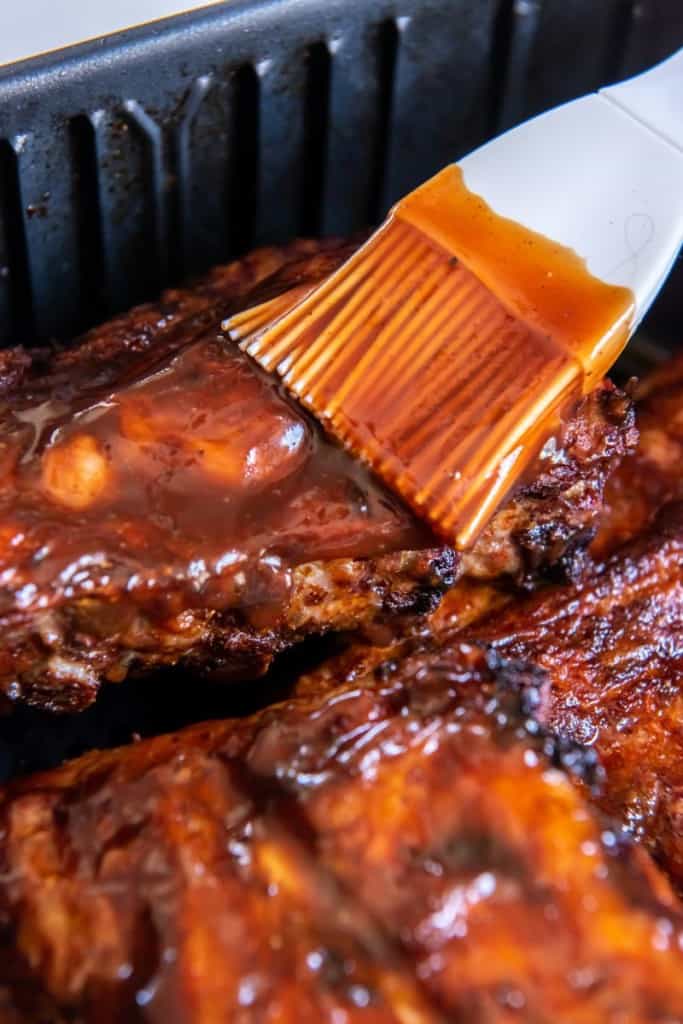 adding sauce to ribs in air fryer