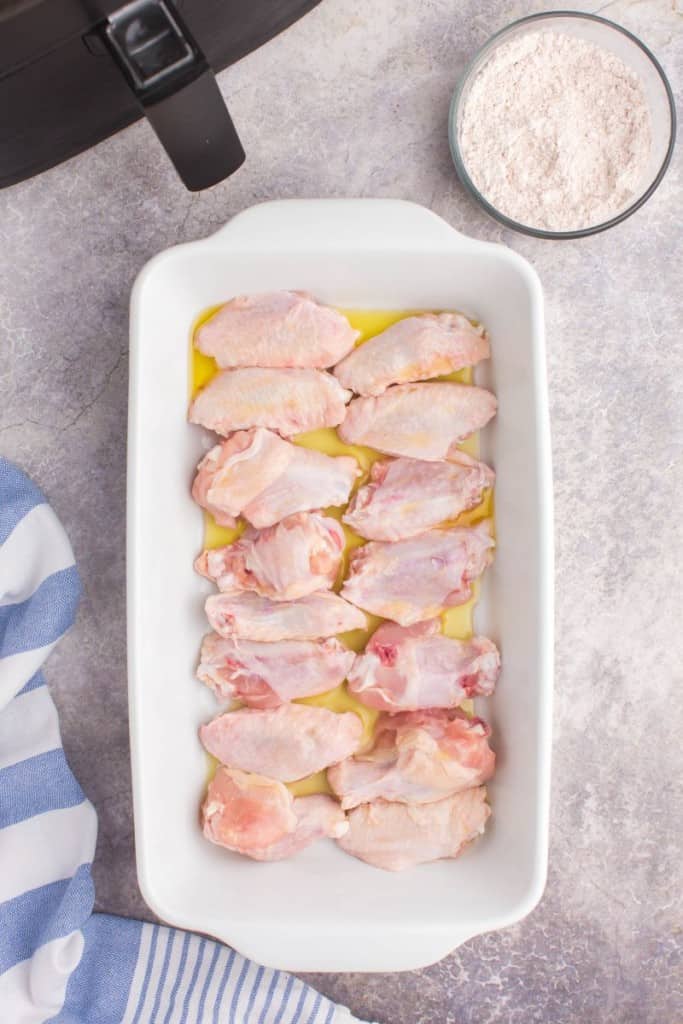 raw chicken wings in a dish