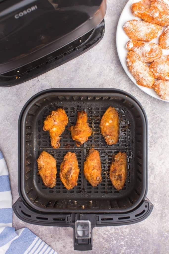 air fryer basket with cooked chicken wings