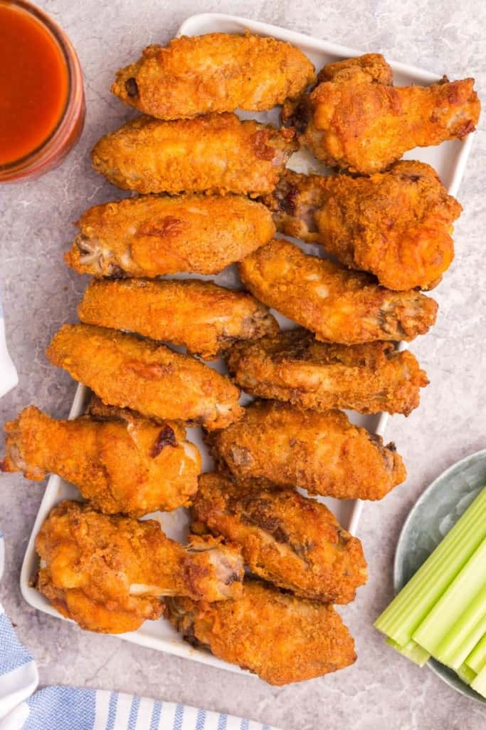 platter overflowing with cooked chicken wings