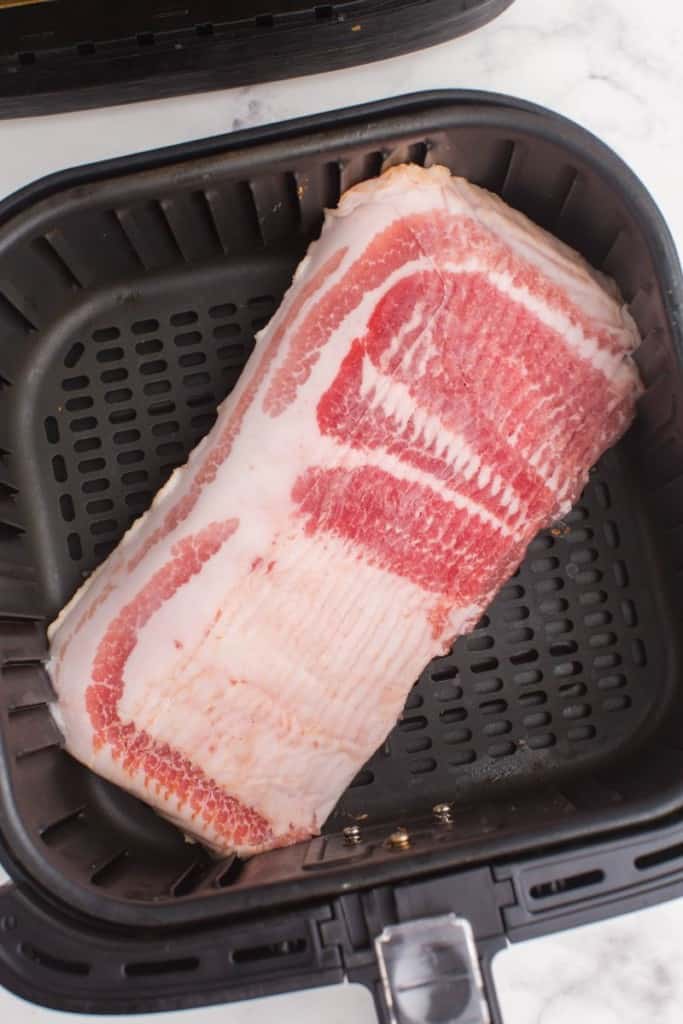 raw ham in an air fryer basket