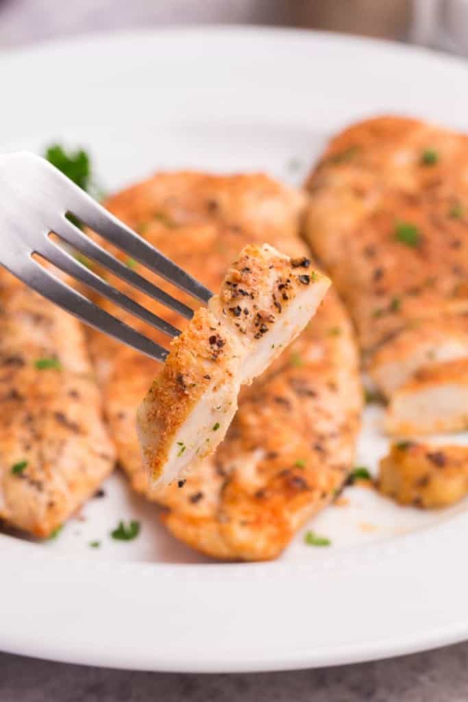 fork with a piece of grilled chicken