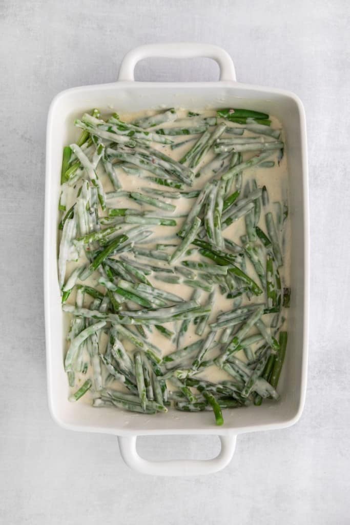 green beans in a casserole dish with sauce