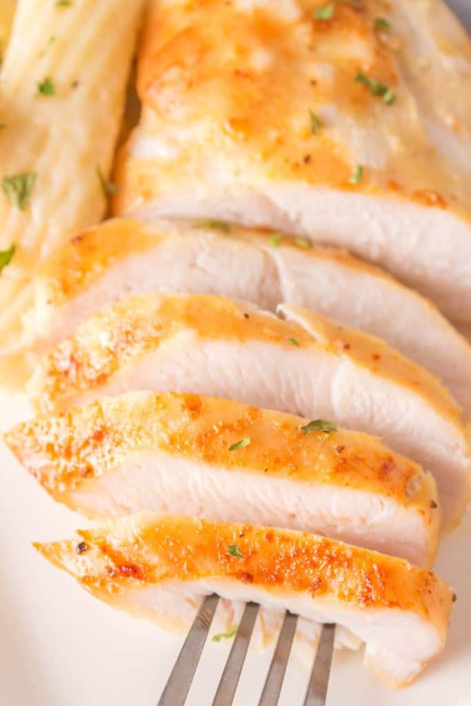 sliced chicken breast with a fork