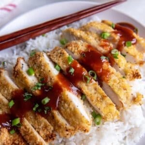 Air fryer chicken katsu being served over rice with sauce on top.