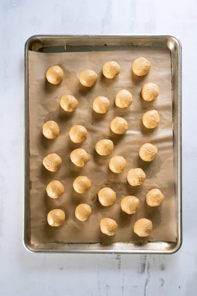 3 ingredient peanut butter balls on a cookie sheet
