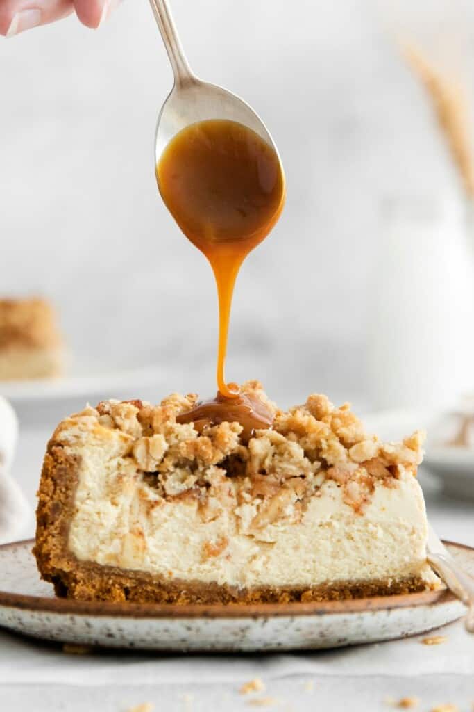 caramel drizzled over apple crumble cheesecake