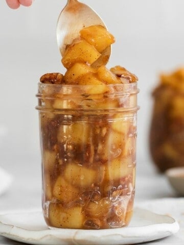 jar with a spoon in it with cinnamon roll apple pie filling