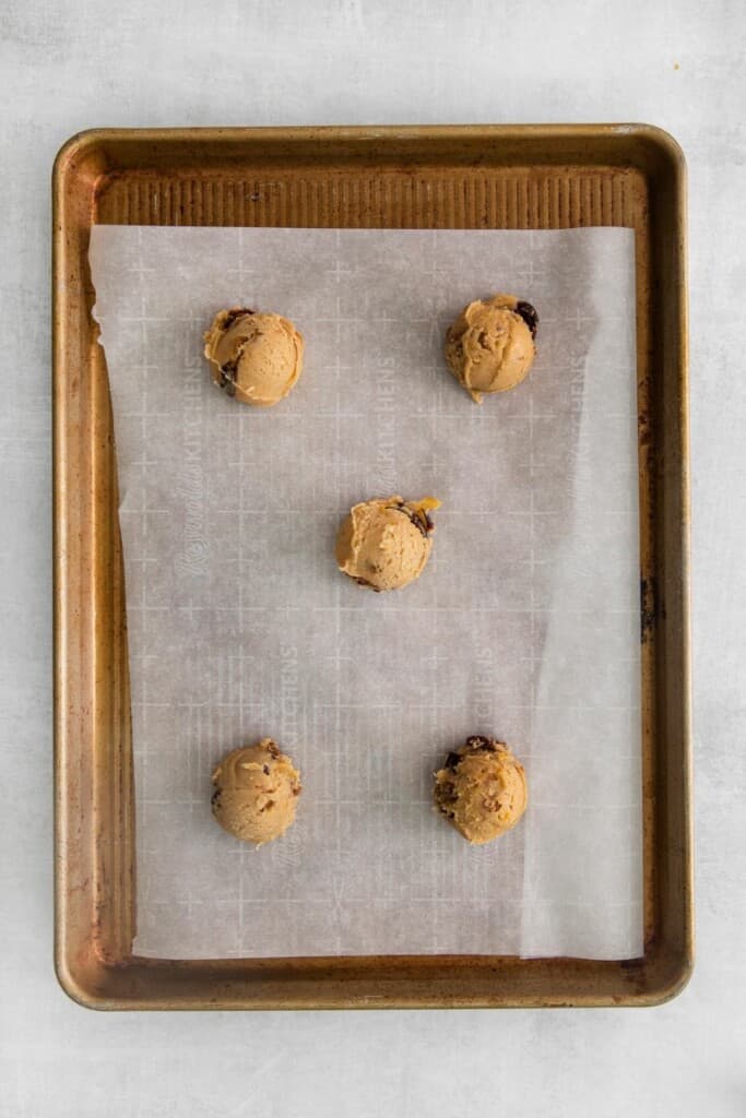 fruitcake cookie dough balls on baking sheet