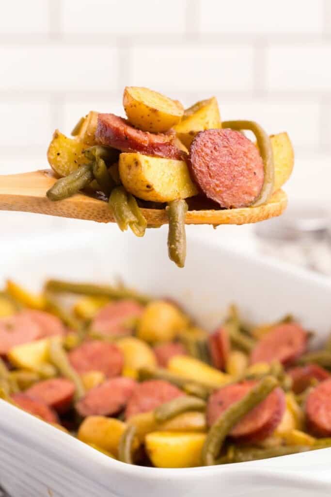 spoon with potatoes, sausage, and green beans