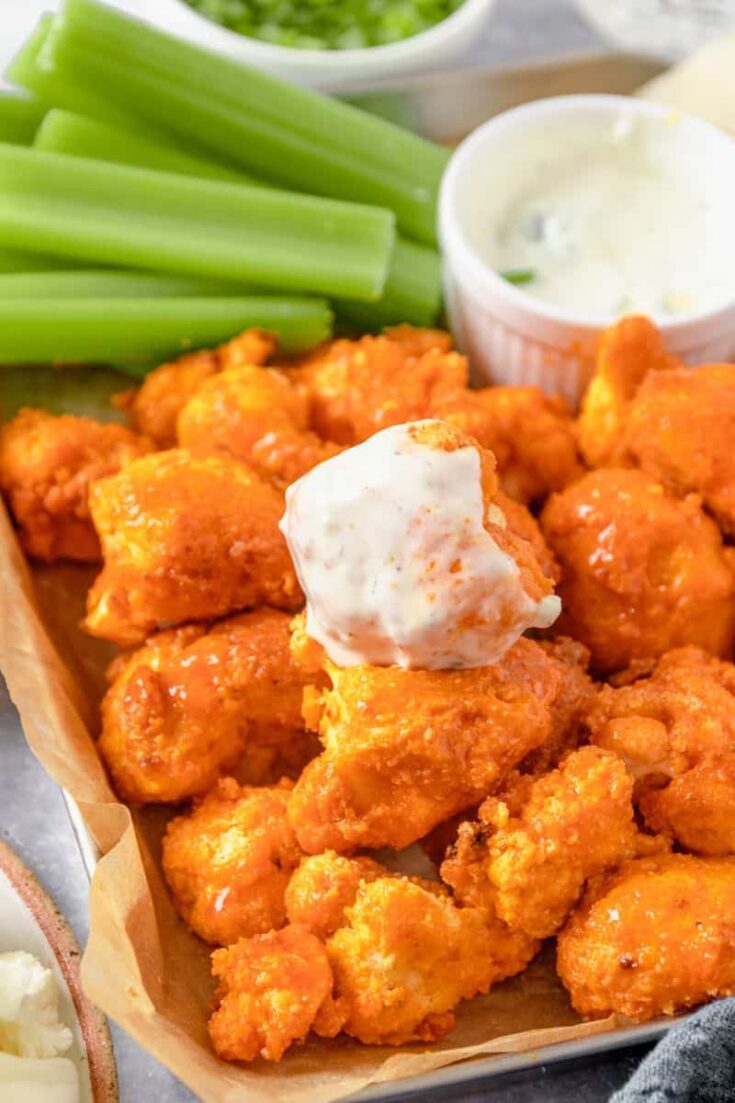 cauliflower wings dipped in sauce