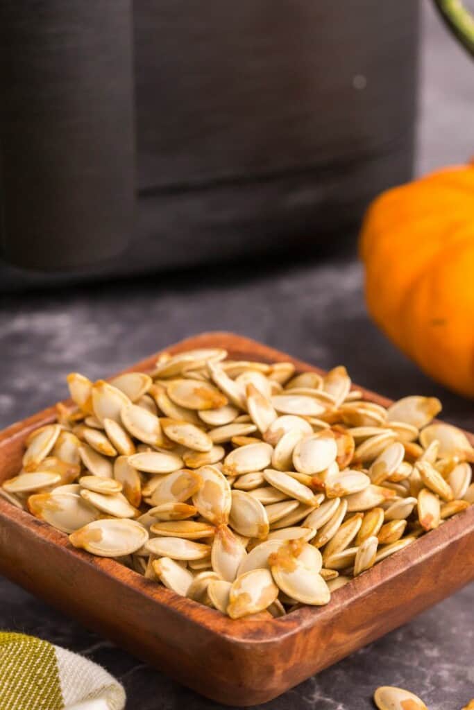 side view of pumpkin seeds in a bowl