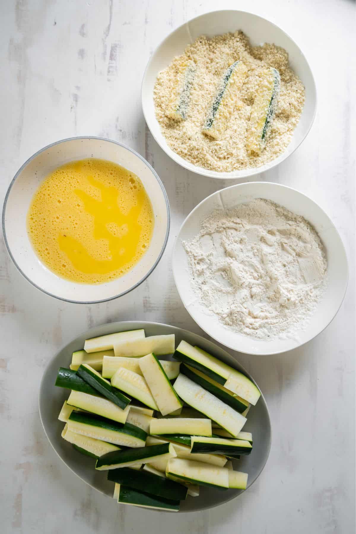Zucchini fries lastly being dipped into the panko breadcrumbs.