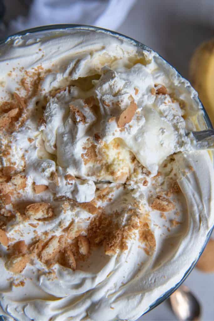 The top of the banana pudding recipe with cool whip to show crumbles of Nilla wafers and the super creamy texture.