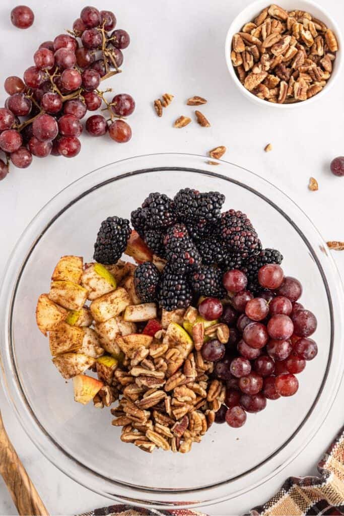 The fruits and pecans in a clear bowl about to be tossed into my autumn fruit salad.