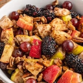 Close up of the Thanksgiving fruit salad in a white bowl.
